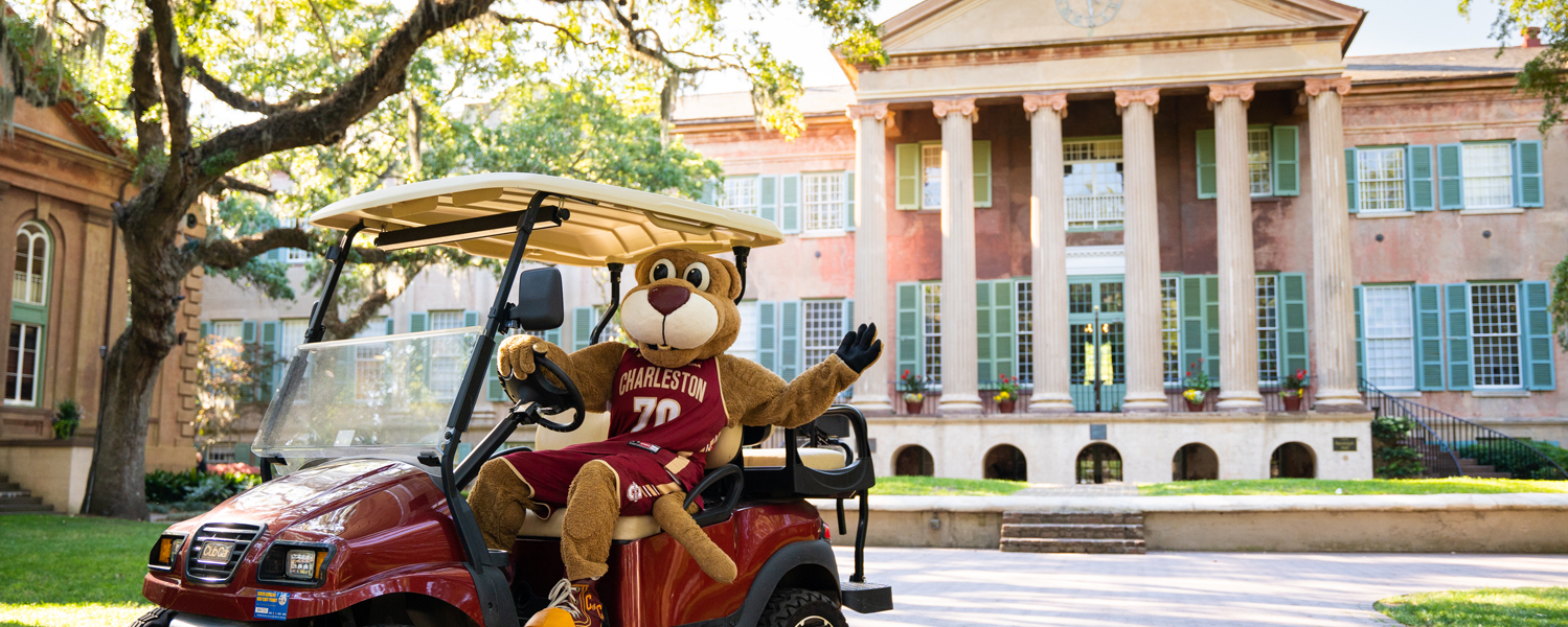 College of Charleston Mascot on golf cart outside of the university building